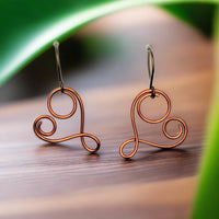 Spiral heart earrings that abstractly resemble a mother and child